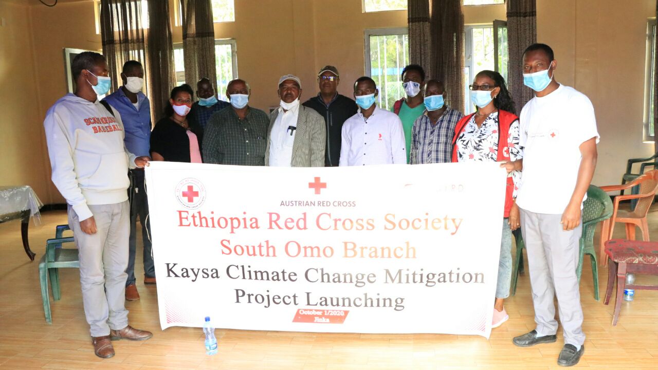 Branch members and officials hold up a banner with the name of the project